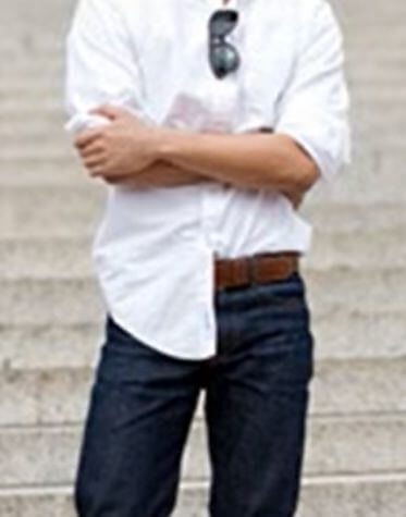 A man wearing a half-tucked shirt