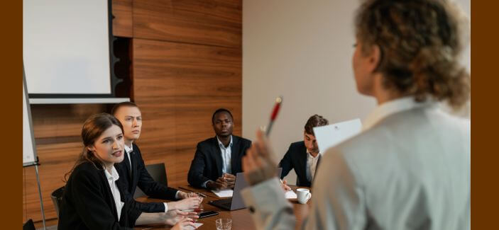 A woman leader and her subordinates brainstorming in the manner of democratic leadership style