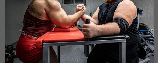 Two men in an arm contest, the effect of masculinity society