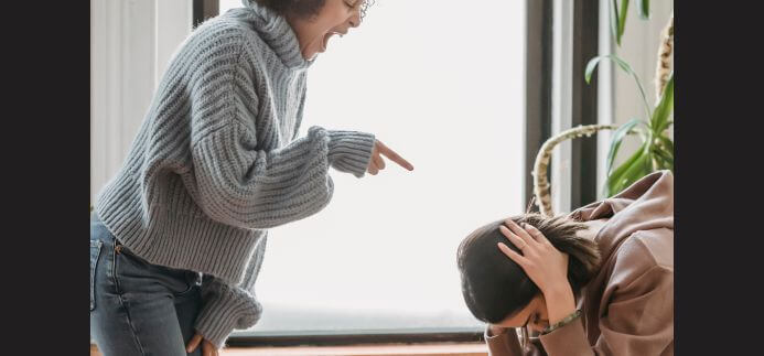 A woman displaying abrasive behaviours towards another woman