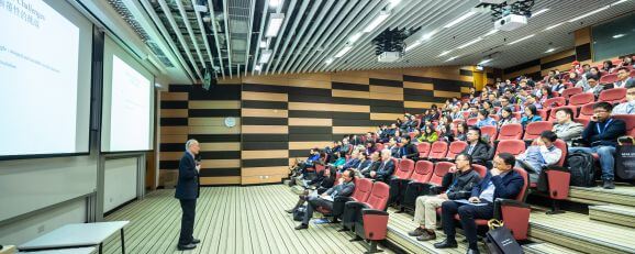 A man addressing an audience to demonstrate social power