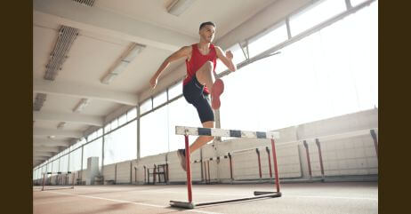 A man jumping a bar to depict the mastery of physical health towards life mastery