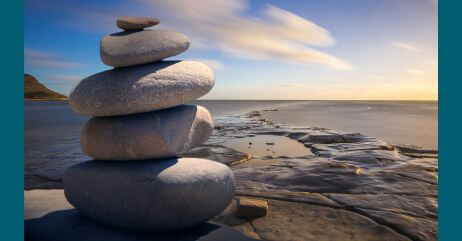 A spiritual scene of stones on top of each other, depicting the route of life mastery