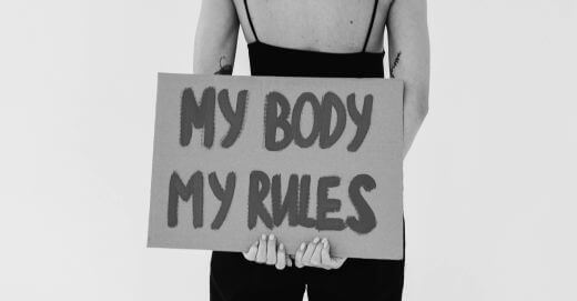 A lady with a placard with the inscription - my body, my rules, demonstrating feminism