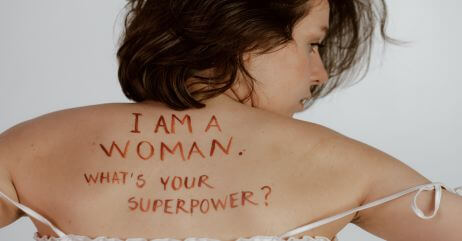 A woman with feminism inscription on her back