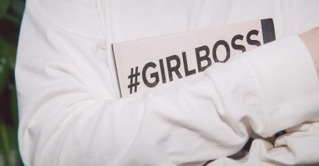 A lady holds an inscription "the girl boss"