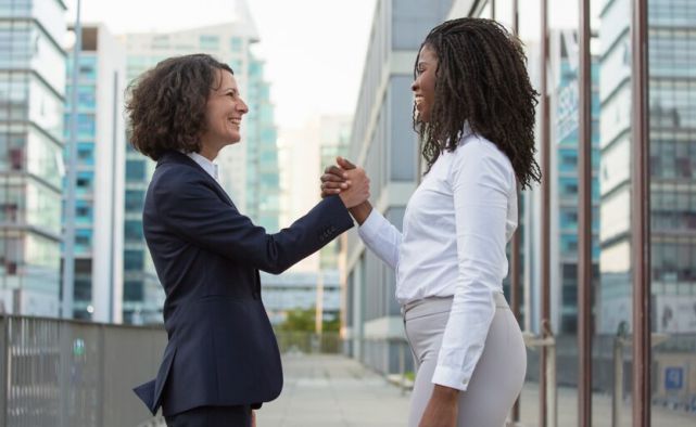 Two women showing respects