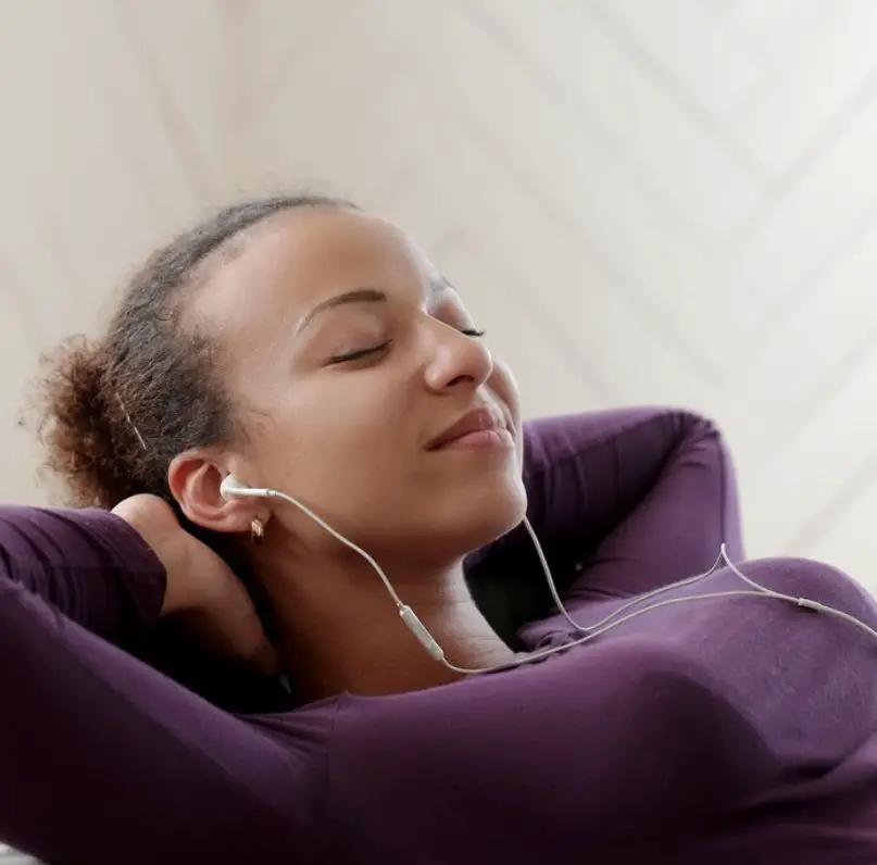 A lady listening to music - an example of mental self-care