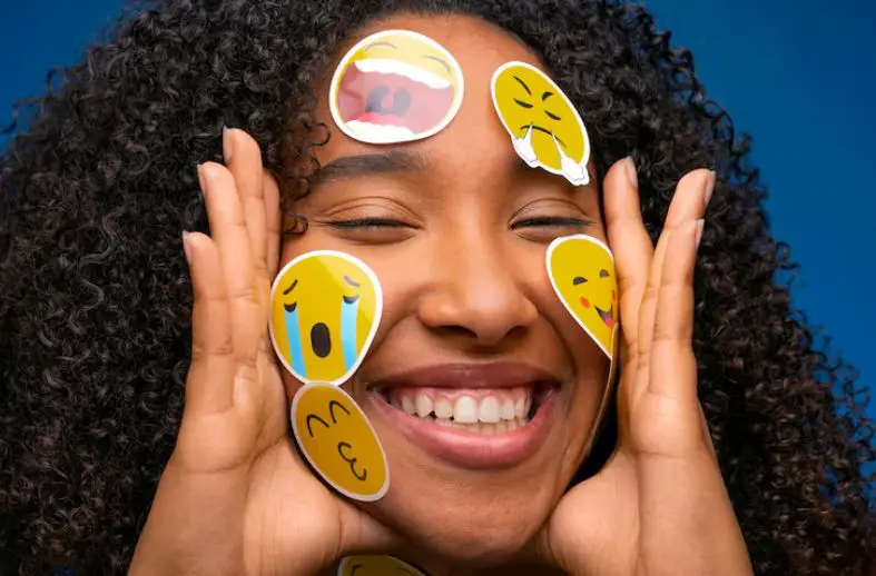 What Are Emotions? A Guide to the Power, Purpose, and Nature of Feelings 5 What Are Emotions? A lady displaying emojis of different emotions