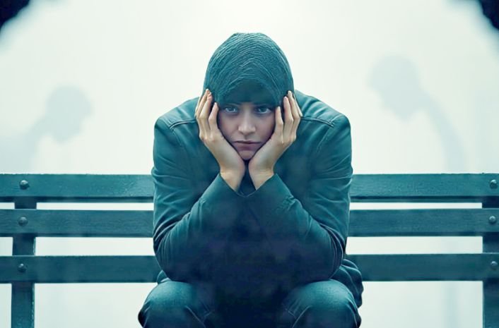 A man sitting with hands under the jaw depicting self-doubt